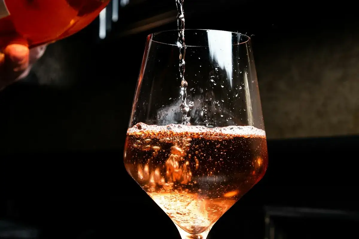 Sparkling rosé being poured into a wine glass